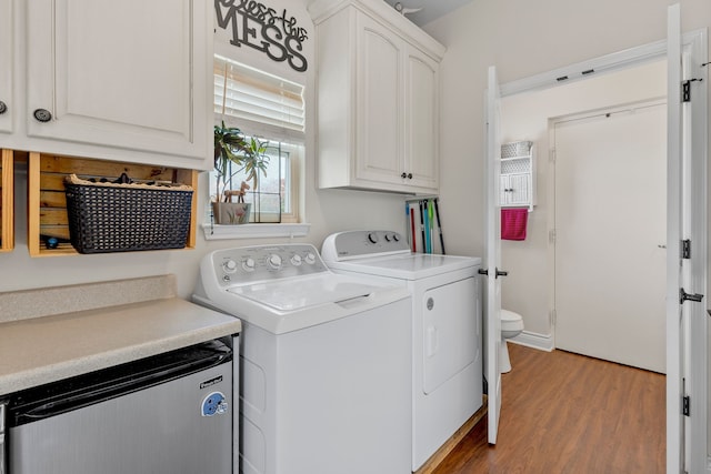 washroom featuring wood finished floors and washer and clothes dryer