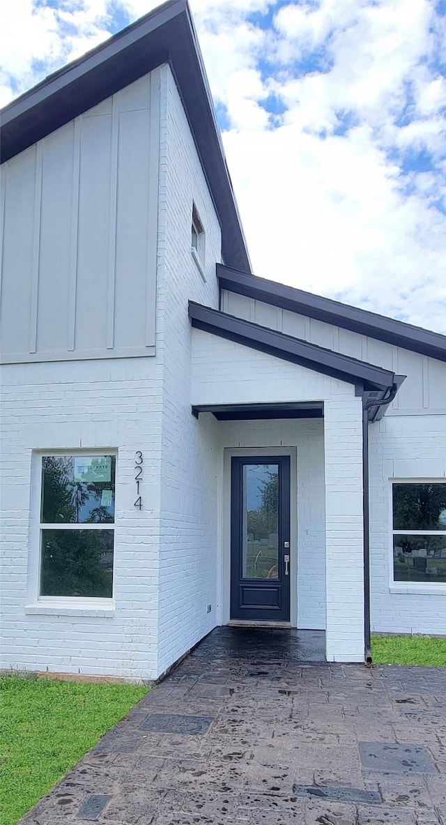 property entrance with brick siding