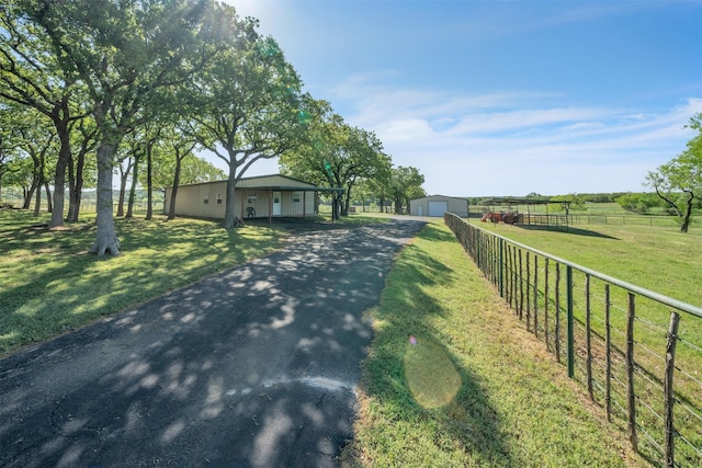 200 Leea Ln, Weatherford, TX 76087 - exterior space with aphalt driveway, fence, a front lawn, an outdoor structure, and a detached garage