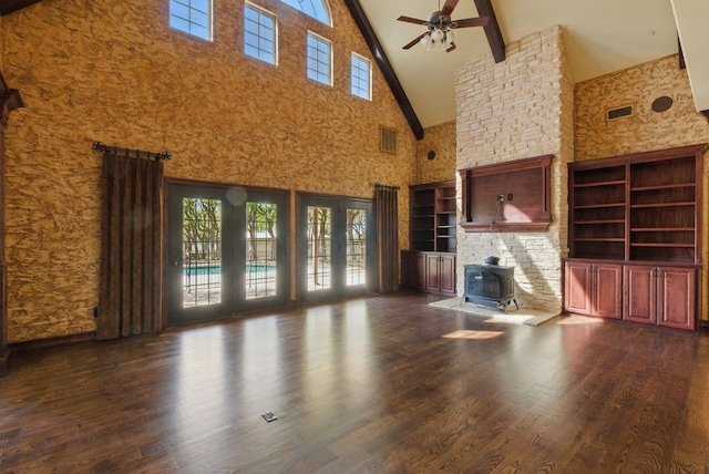 200 Leea Ln, Weatherford, TX 76087 - unfurnished living room featuring wood finished floors, a wood stove, beam ceiling, high vaulted ceiling, and ceiling fan