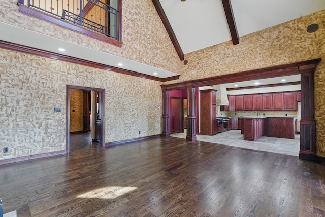 200 Leea Ln, Weatherford, TX 76087 - unfurnished living room with beamed ceiling, wood finished floors, ornate columns, and high vaulted ceiling
