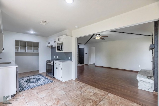 1026 Baylor St, Abilene, TX 79602 - kitchen featuring a sink, stainless steel appliances, white cabinetry, ceiling fan, and light countertops