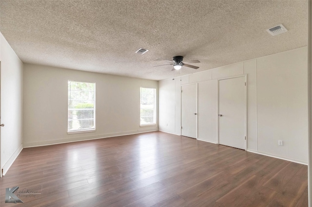1026 Baylor St, Abilene, TX 79602 - unfurnished bedroom featuring ceiling fan, a textured ceiling, dark wood-type flooring, and visible vents