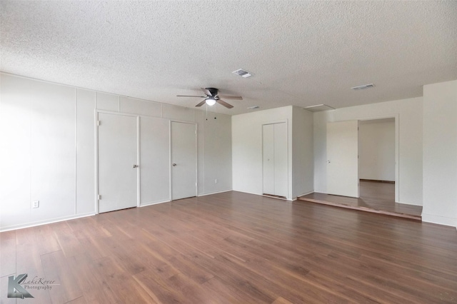 1026 Baylor St, Abilene, TX 79602 - unfurnished bedroom featuring a textured ceiling, visible vents, wood finished floors, and multiple closets