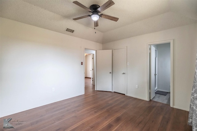 1026 Baylor St, Abilene, TX 79602 - unfurnished bedroom featuring a textured ceiling, visible vents, wood finished floors, and ensuite bathroom