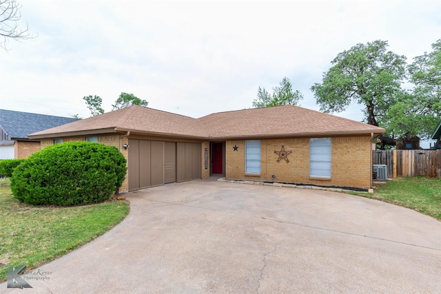 1026 Baylor St, Abilene, TX 79602 - ranch-style home with concrete driveway, brick siding, roof with shingles, and fence