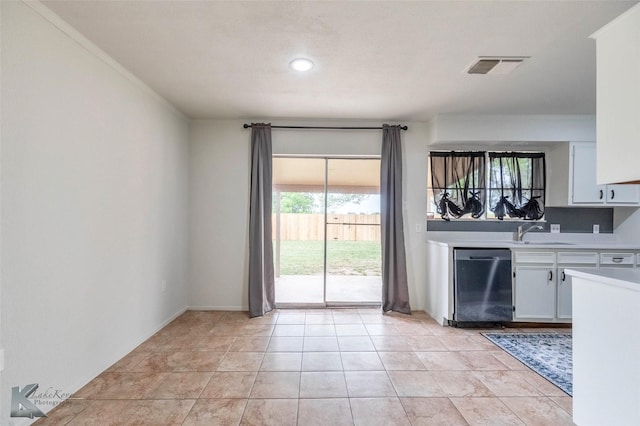 1026 Baylor St, Abilene, TX 79602 - kitchen featuring a sink, white cabinets, stainless steel dishwasher, visible vents, and light countertops
