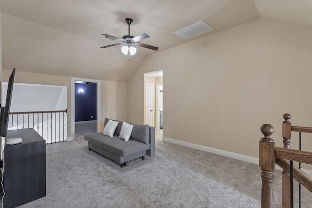 interior space featuring visible vents, a ceiling fan, carpet flooring, vaulted ceiling, and an upstairs landing