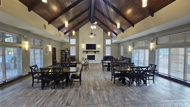 dining room featuring a ceiling fan, wood finished floors, and high vaulted ceiling