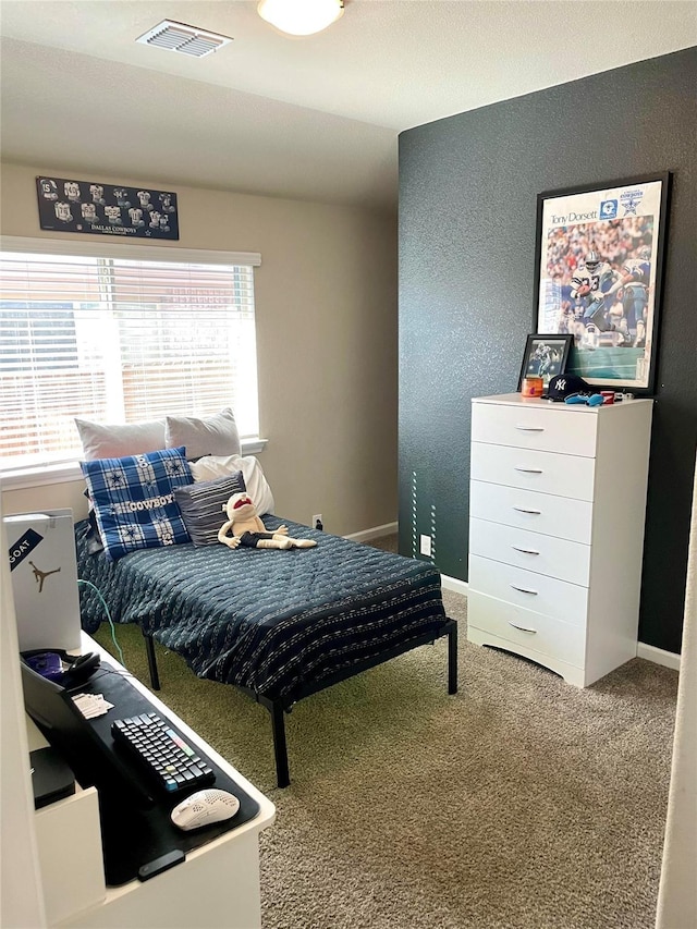 bedroom featuring carpet floors, visible vents, and baseboards