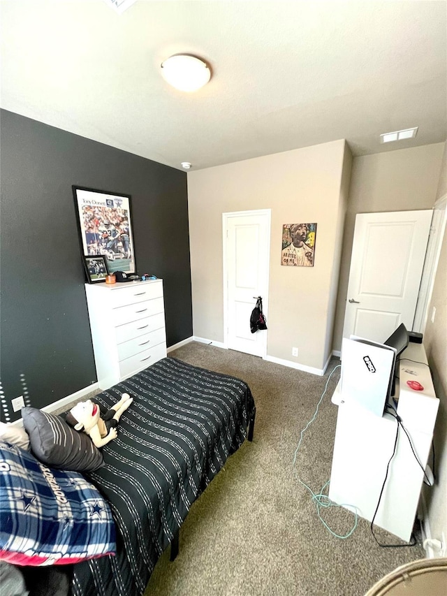 bedroom featuring baseboards, visible vents, and carpet