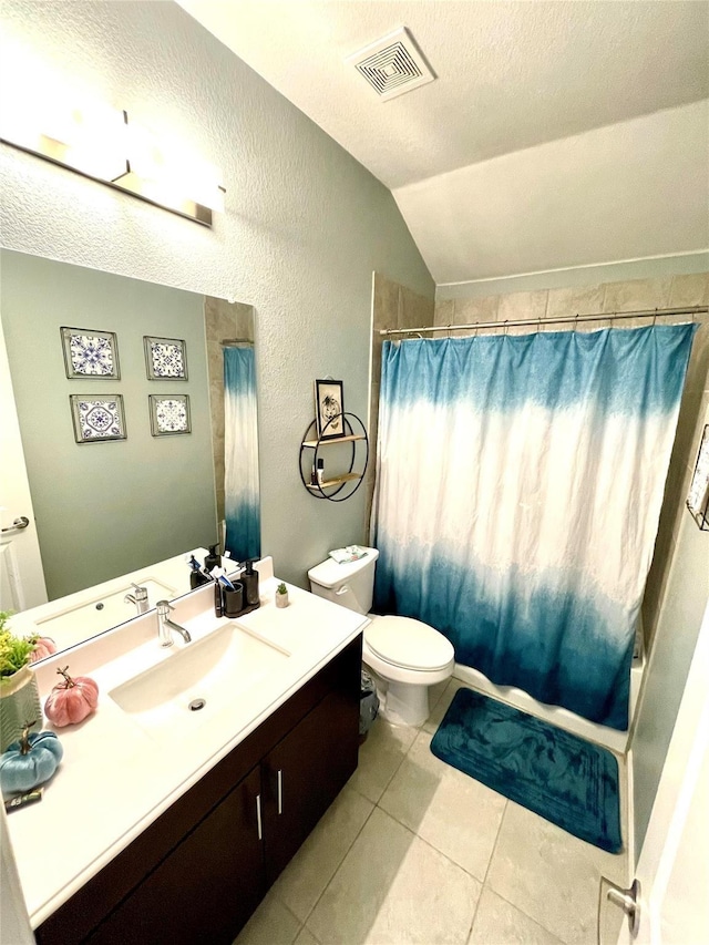 full bathroom featuring toilet, tile patterned floors, vanity, lofted ceiling, and visible vents