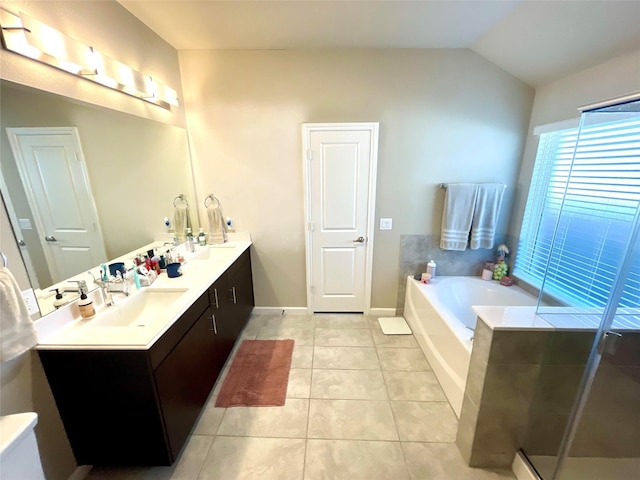 full bath featuring tile patterned floors, double vanity, vaulted ceiling, a shower stall, and a garden tub