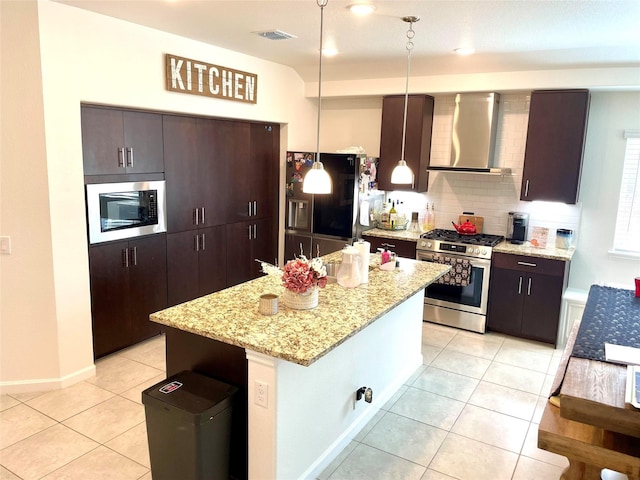 kitchen with wall chimney exhaust hood, built in microwave, visible vents, fridge with ice dispenser, and stainless steel gas range oven