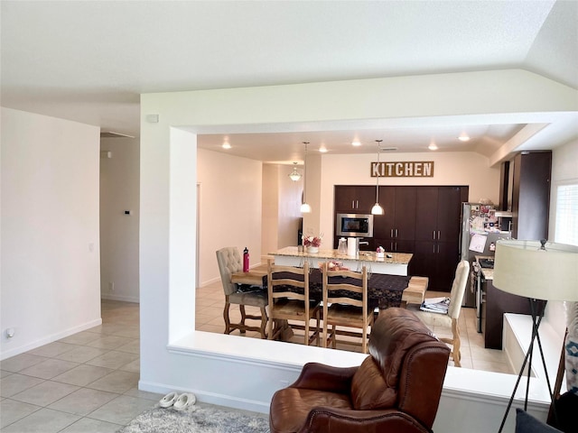 dining space featuring light tile patterned flooring, lofted ceiling, and recessed lighting