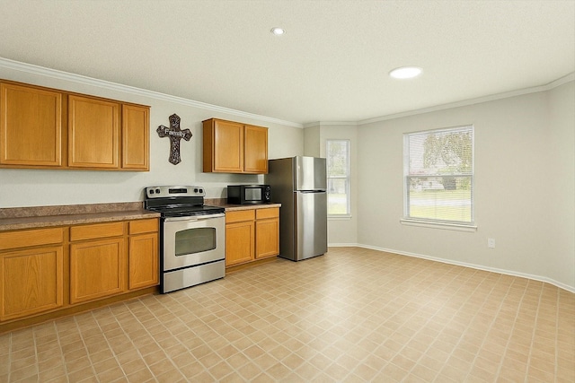 4823 Topaz Ln, Granbury, TX 76049 - kitchen with baseboards, crown molding, light floors, brown cabinetry, and appliances with stainless steel finishes