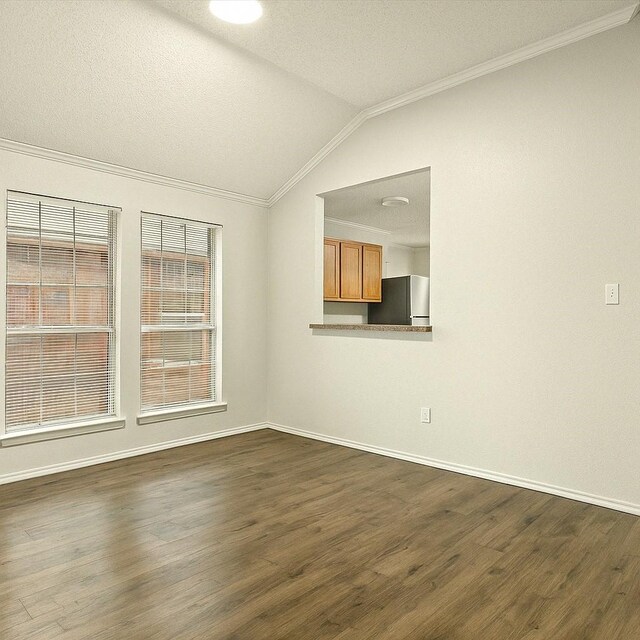 4823 Topaz Ln, Granbury, TX 76049 - spare room with lofted ceiling, baseboards, dark wood-type flooring, and ornamental molding