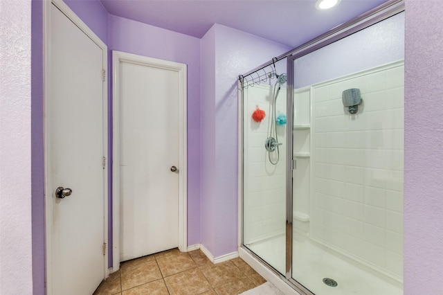 full bath with tile patterned floors and a stall shower