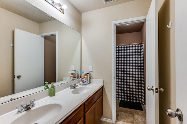 full bath with a shower with curtain, double vanity, visible vents, and a sink