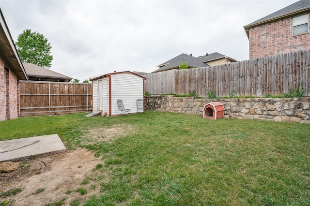 view of yard with a fenced backyard, an outdoor structure, and a shed