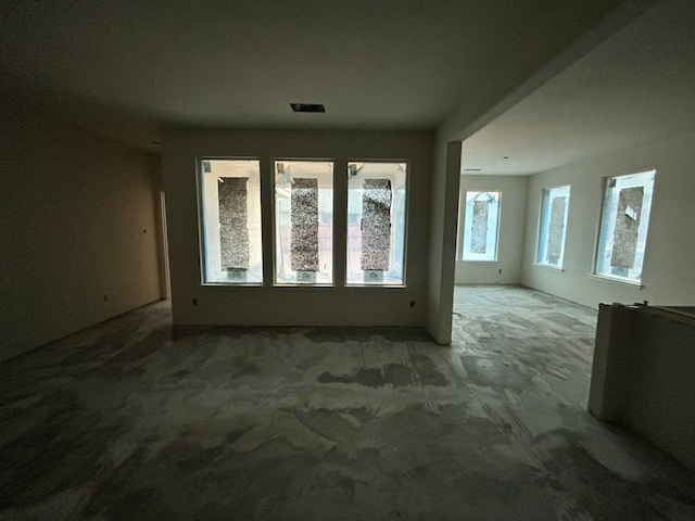 unfurnished room with visible vents