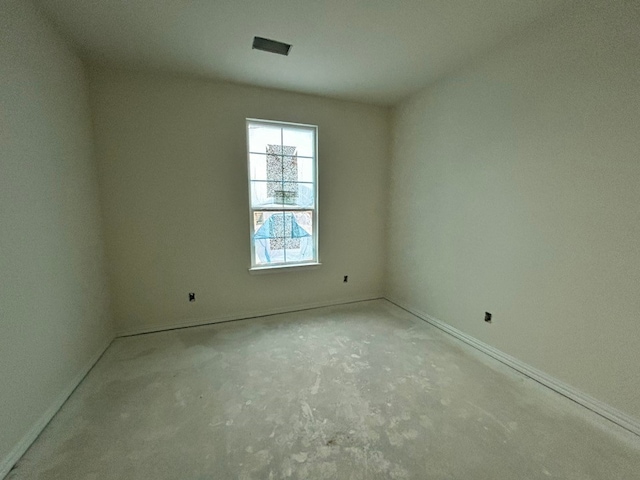 empty room featuring visible vents and baseboards