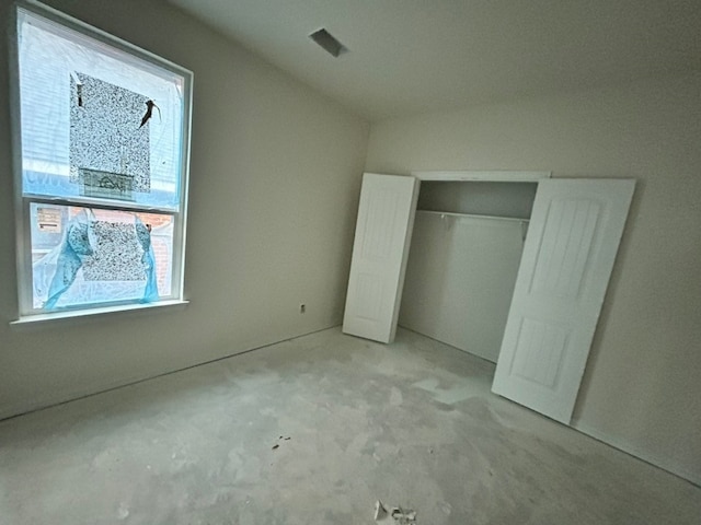 unfurnished bedroom with visible vents and a closet
