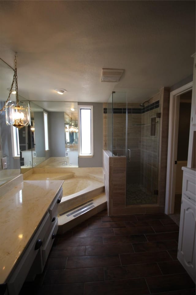 634 Ray Ave, Desoto, TX 75115 - bathroom featuring a bath, a chandelier, vanity, and a shower stall
