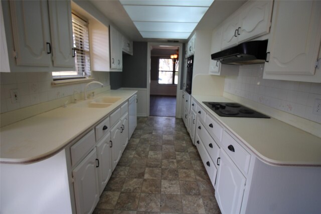 634 Ray Ave, Desoto, TX 75115 - kitchen featuring under cabinet range hood, dishwasher, a sink, black electric stovetop, and white cabinetry