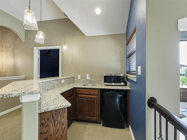 kitchen with light stone counters, a sink, fridge, stainless steel microwave, and baseboards