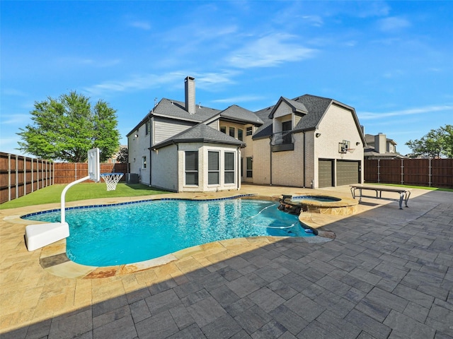view of pool with a fenced backyard, a pool with connected hot tub, and a patio