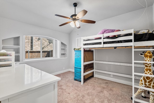 unfurnished bedroom with light carpet, vaulted ceiling, baseboards, and a ceiling fan