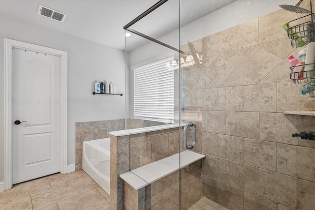 bathroom featuring visible vents, a garden tub, and a stall shower