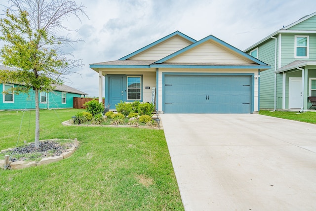 view of front facade with a garage, a front yard, and concrete driveway