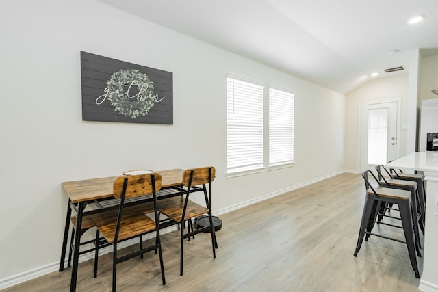 dining room featuring recessed lighting, lofted ceiling, light wood finished floors, and baseboards