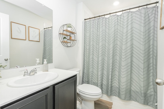 bathroom with shower / bath combo, toilet, vanity, and wood finished floors