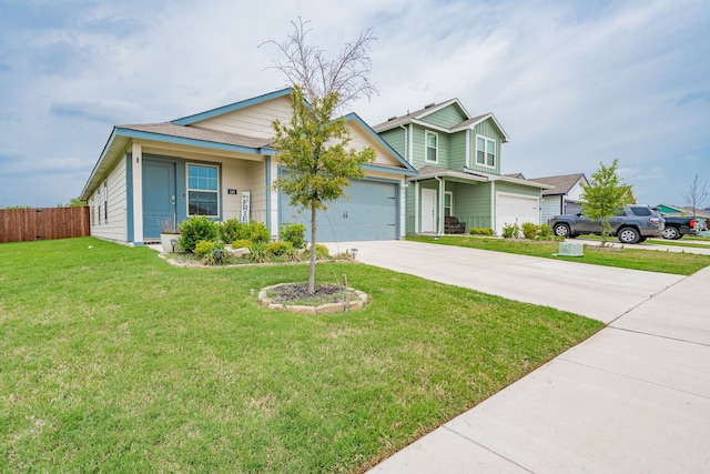view of front facade featuring an attached garage, driveway, fence, and a front lawn