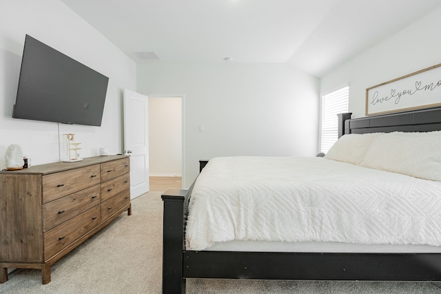 bedroom with light carpet, vaulted ceiling, and visible vents