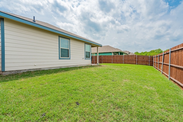 view of yard with a fenced backyard