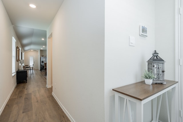 corridor with baseboards, wood finished floors, and recessed lighting