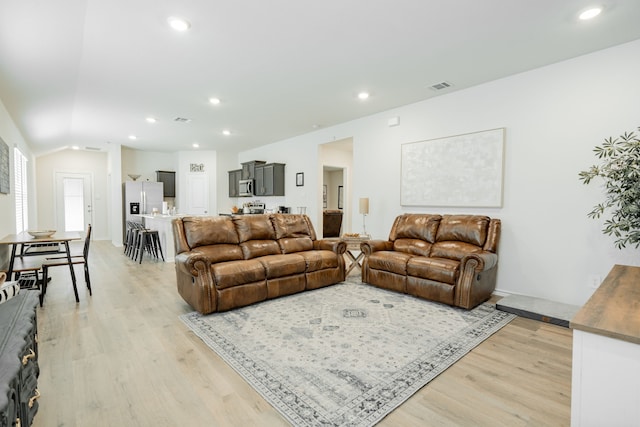 living room featuring light wood finished floors, visible vents, and recessed lighting
