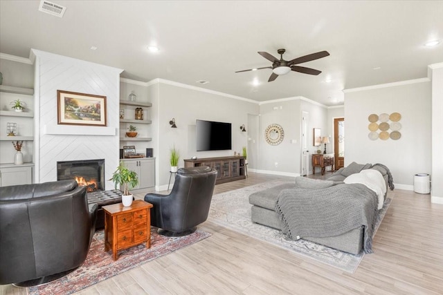 12409 Messer Ct, Fort Worth, TX 76126 - living area featuring a ceiling fan, baseboards, crown molding, a fireplace, and wood finished floors