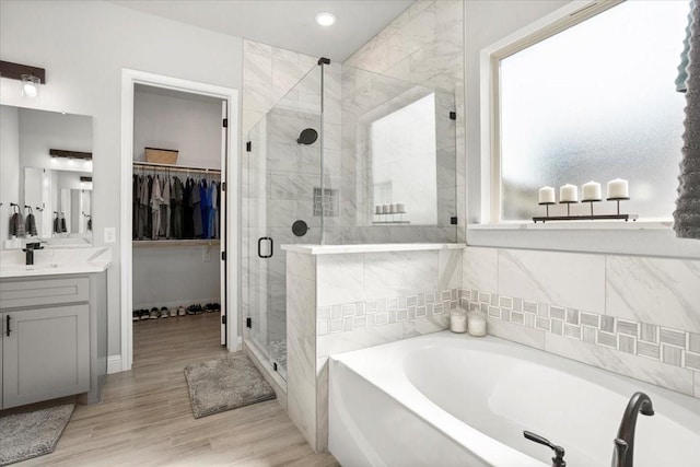 12409 Messer Ct, Fort Worth, TX 76126 - full bath with a bath, vanity, a shower stall, a spacious closet, and wood finished floors