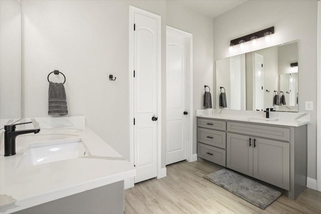 12409 Messer Ct, Fort Worth, TX 76126 - bathroom with double vanity, wood finished floors, and baseboards