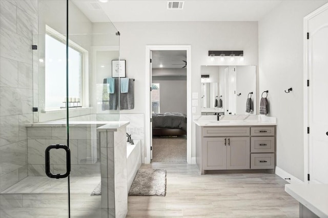 12409 Messer Ct, Fort Worth, TX 76126 - full bathroom with ensuite bathroom, a garden tub, vanity, a shower stall, and wood finished floors
