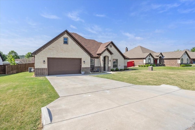 12409 Messer Ct, Fort Worth, TX 76126 - french country home featuring brick siding, concrete driveway, an attached garage, cooling unit, and stone siding