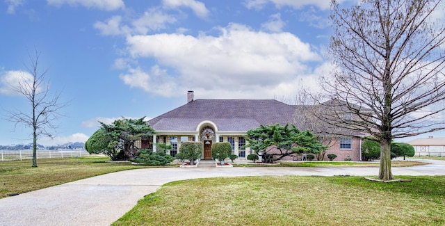 2176 English Rd, Rockwall, TX 75032 - view of front of home with a chimney, fence, a front yard, and curved driveway