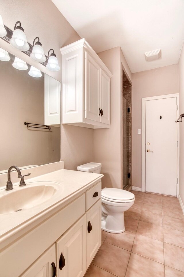 2176 English Rd, Rockwall, TX 75032 - full bathroom featuring tile patterned floors, vanity, a shower stall, and toilet