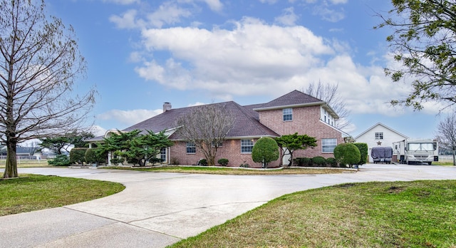 2176 English Rd, Rockwall, TX 75032 - french country style house with a chimney, a front lawn, brick siding, and curved driveway