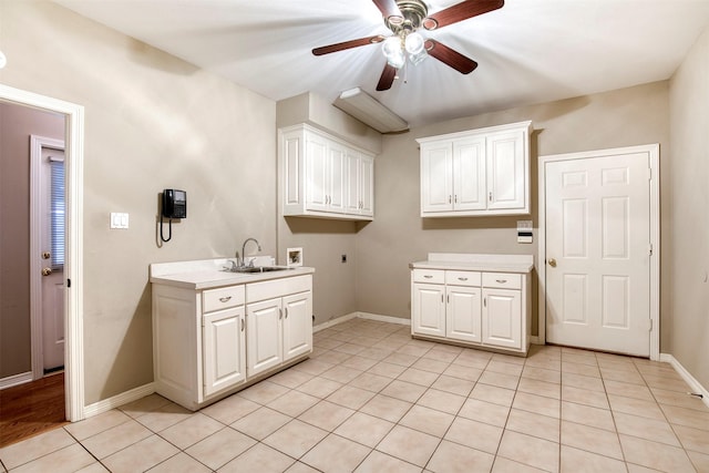 2176 English Rd, Rockwall, TX 75032 - clothes washing area featuring a ceiling fan, a sink, light tile patterned floors, cabinet space, and washer hookup